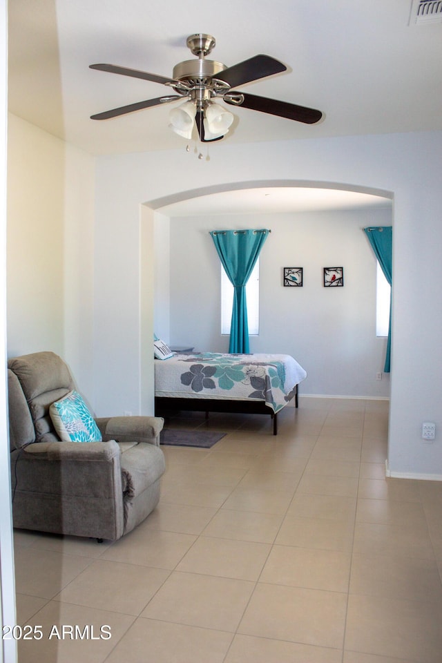 15148 W Sells Dr, Goodyear, AZ 85395 - tiled bedroom featuring a ceiling fan, arched walkways, and baseboards