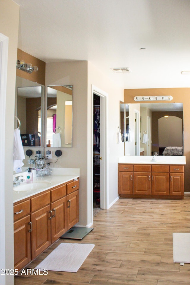 15148 W Sells Dr, Goodyear, AZ 85395 - bathroom featuring vanity, wood finished floors, baseboards, and a spacious closet
