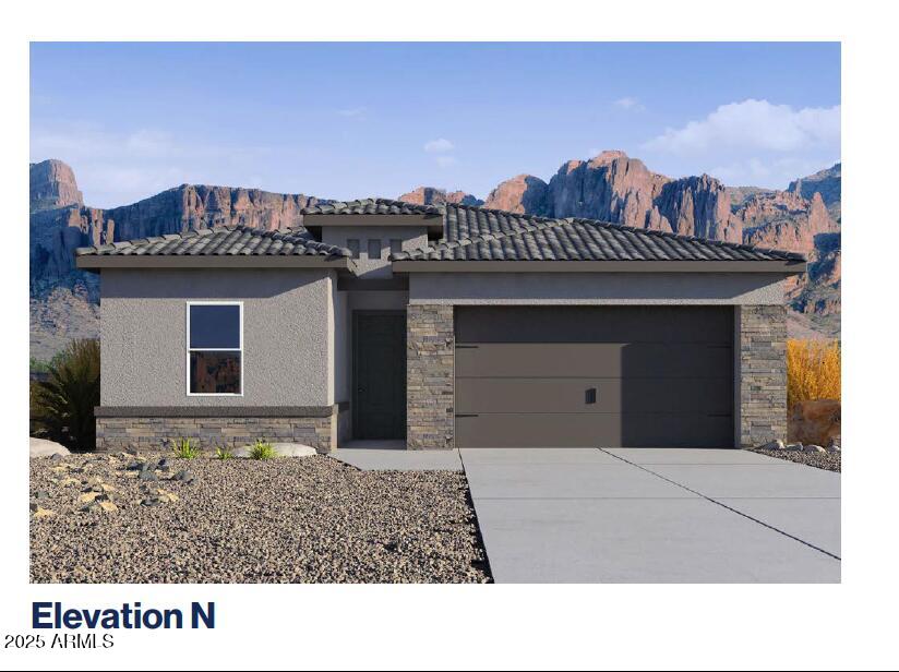 prairie-style house featuring stone siding, stucco siding, a tiled roof, an attached garage, and driveway