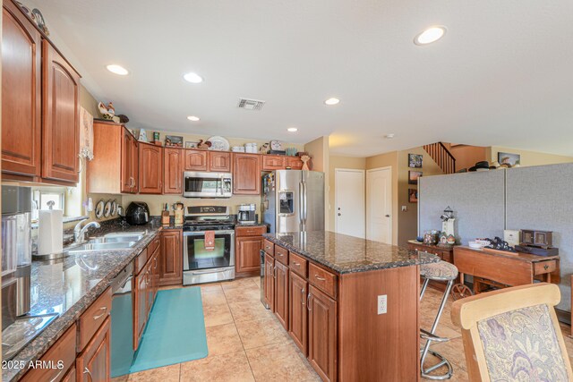 44890 W Desert Garden Rd, Maricopa, AZ 85139 - kitchen with appliances with stainless steel finishes, a sink, brown cabinets, a center island, and recessed lighting