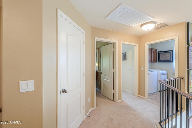 44890 W Desert Garden Rd, Maricopa, AZ 85139 - hall featuring washer and clothes dryer, an upstairs landing, light colored carpet, and baseboards