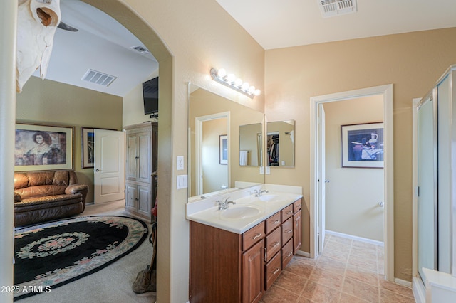 44890 W Desert Garden Rd, Maricopa, AZ 85139 - full bathroom featuring double vanity, vaulted ceiling, and baseboards