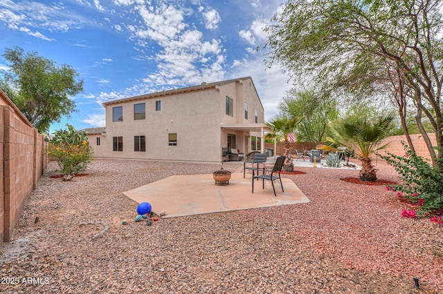 44890 W Desert Garden Rd, Maricopa, AZ 85139 - rear view of property featuring a patio area, a fenced backyard, stucco siding, and an outdoor fire pit