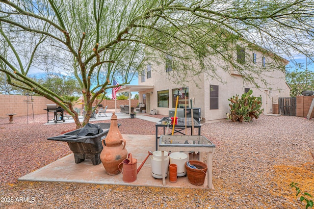 44890 W Desert Garden Rd, Maricopa, AZ 85139 - back of house featuring stucco siding, a fenced backyard, and a patio