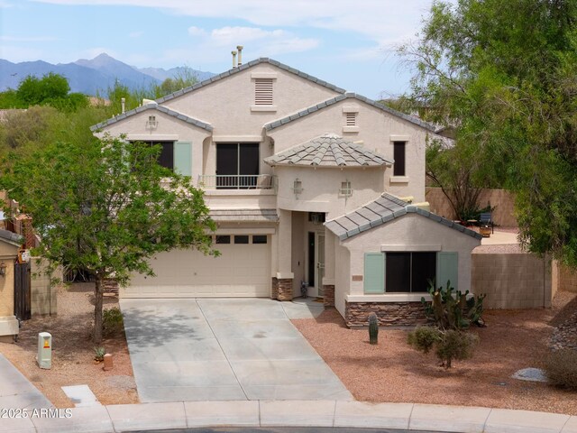 44890 W Desert Garden Rd, Maricopa, AZ 85139 - view of front facade with stucco siding, an attached garage, a tiled roof, driveway, and a mountain view