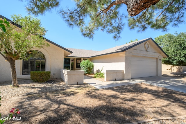 ranch-style house featuring a garage