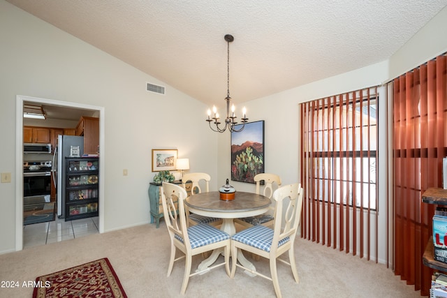 carpeted dining room with an inviting chandelier, a textured ceiling, and vaulted ceiling