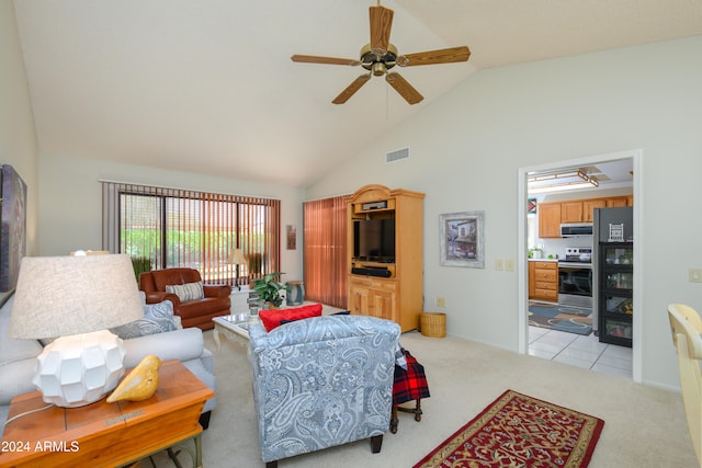 carpeted living room featuring ceiling fan and high vaulted ceiling