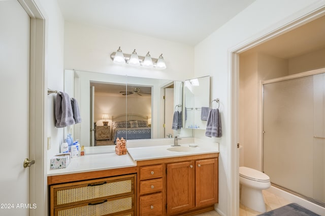 bathroom with toilet, walk in shower, vanity, and tile patterned floors