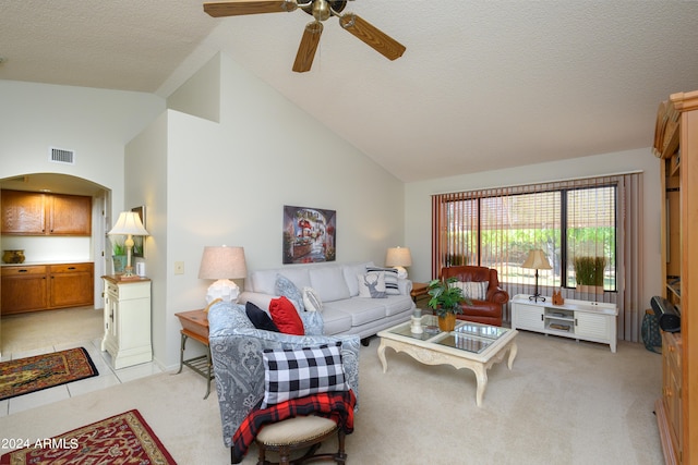 living room featuring light colored carpet, a textured ceiling, high vaulted ceiling, and ceiling fan