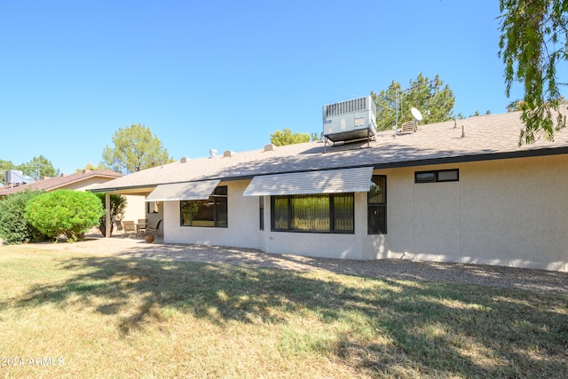 rear view of property with a yard