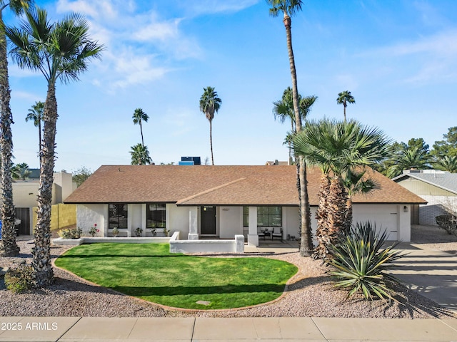 ranch-style home with a front yard