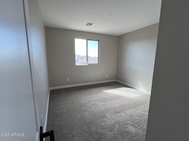 carpeted empty room with baseboards and visible vents