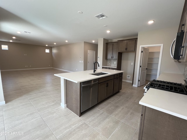 kitchen featuring a sink, visible vents, appliances with stainless steel finishes, and light countertops