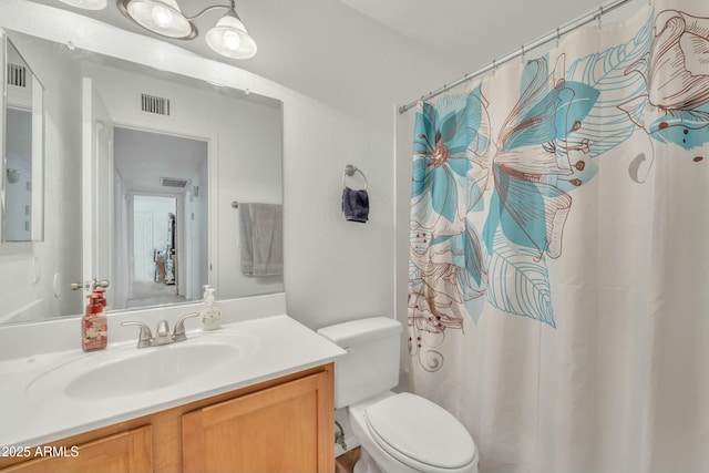 bathroom with vanity, toilet, and walk in shower