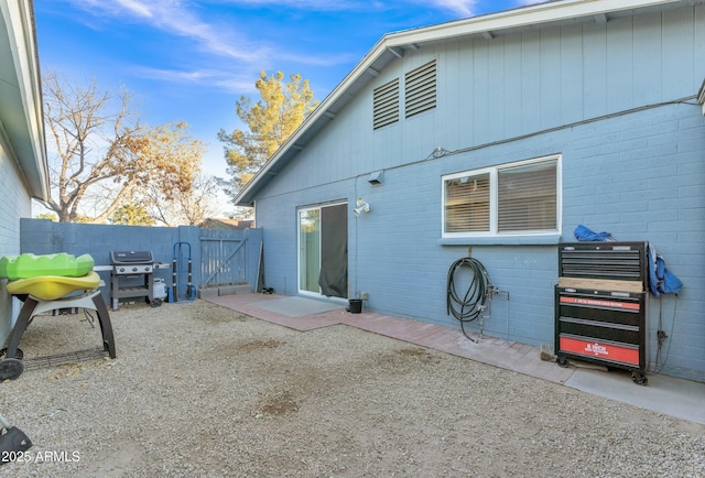 rear view of property featuring heating unit and a patio