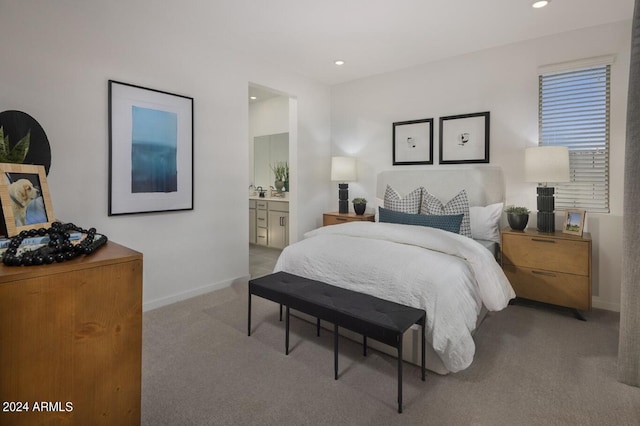 carpeted bedroom featuring ensuite bathroom