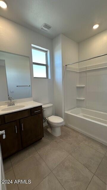 full bathroom featuring vanity, shower / tub combination, toilet, and tile patterned flooring