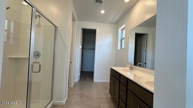 bathroom featuring vanity, tile patterned floors, and an enclosed shower