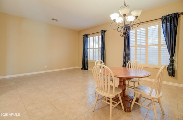 tiled dining space with a chandelier