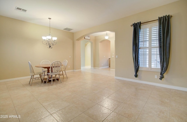 dining area featuring an inviting chandelier and light tile patterned floors