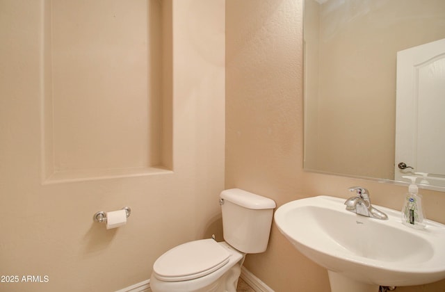 bathroom with toilet and sink