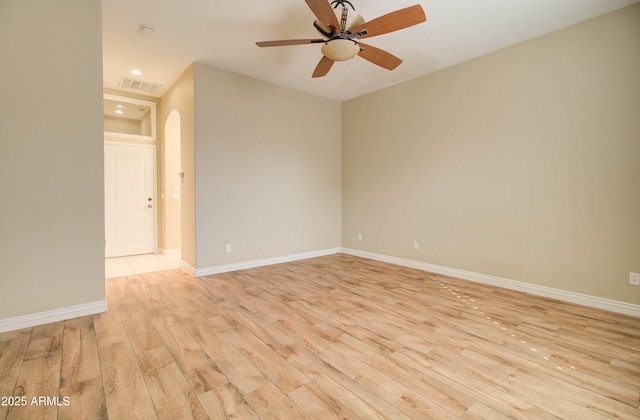 empty room featuring ceiling fan and light hardwood / wood-style flooring