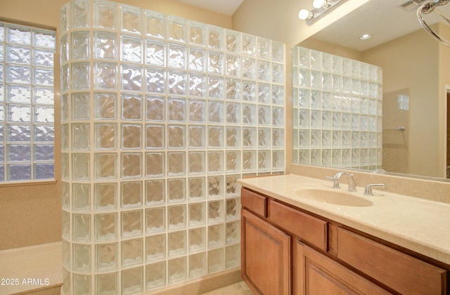 bathroom featuring walk in shower and vanity