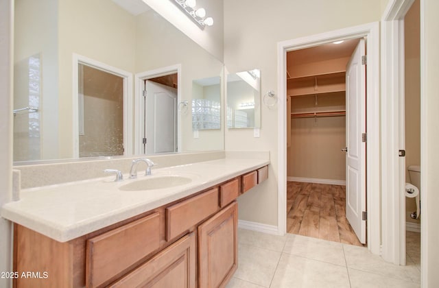 bathroom with vanity, toilet, and tile patterned flooring