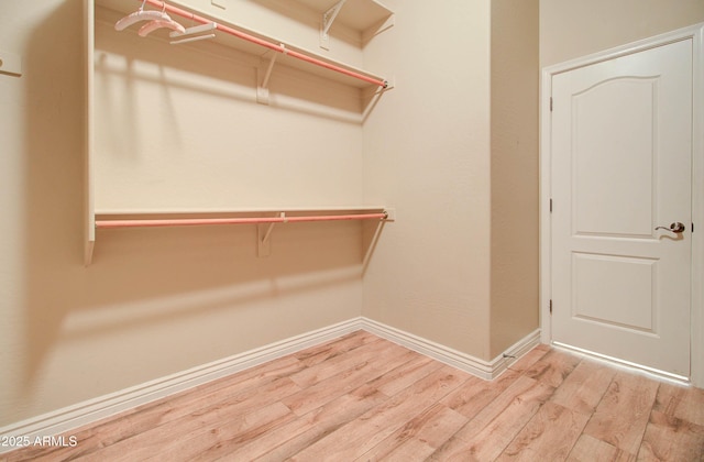 walk in closet featuring light hardwood / wood-style flooring