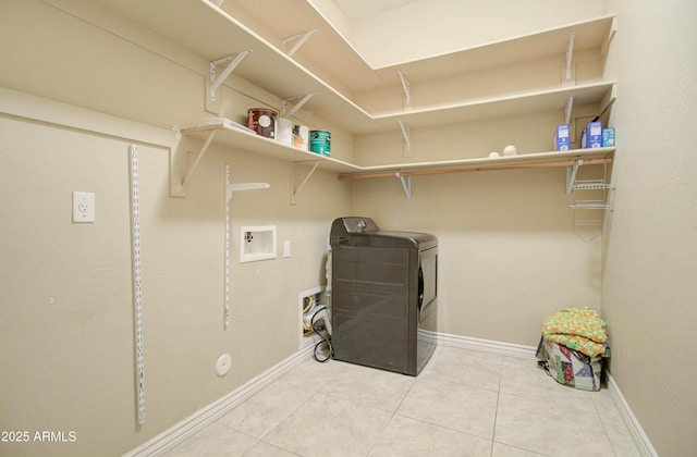 laundry area with washer / clothes dryer and tile patterned flooring