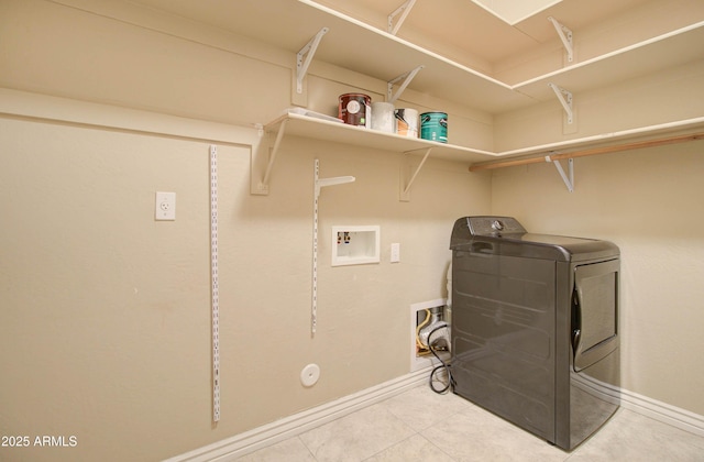 laundry area featuring light tile patterned flooring and washer / dryer