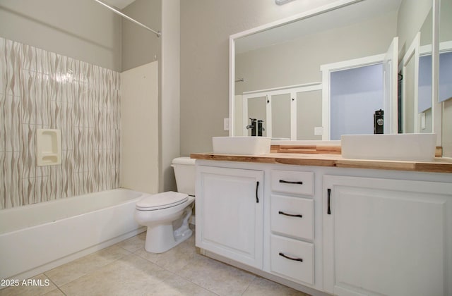 full bathroom with tile patterned flooring, vanity, shower / bathtub combination, and toilet