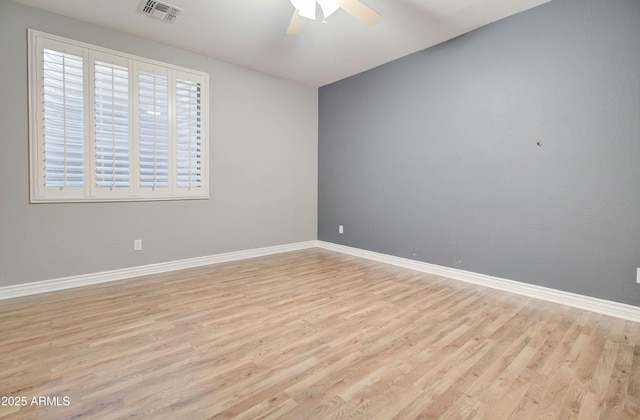 spare room featuring light hardwood / wood-style flooring and ceiling fan