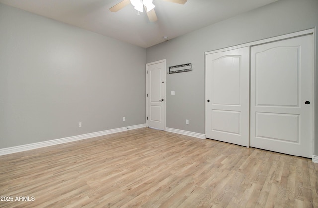 unfurnished bedroom with light hardwood / wood-style floors, a closet, and ceiling fan