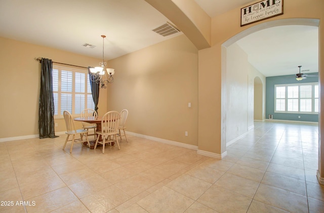 dining area featuring ceiling fan with notable chandelier and light tile patterned floors