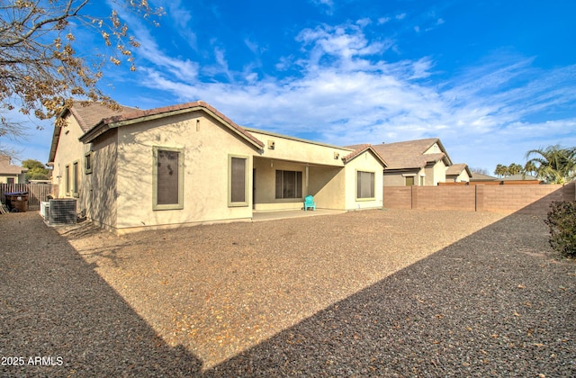 rear view of property featuring cooling unit and a patio