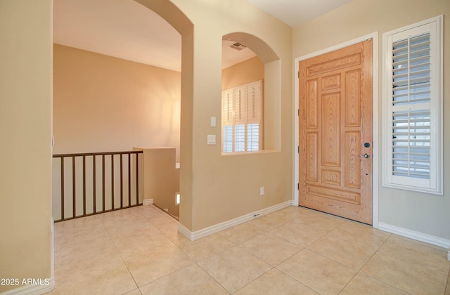 foyer with light tile patterned flooring and a healthy amount of sunlight