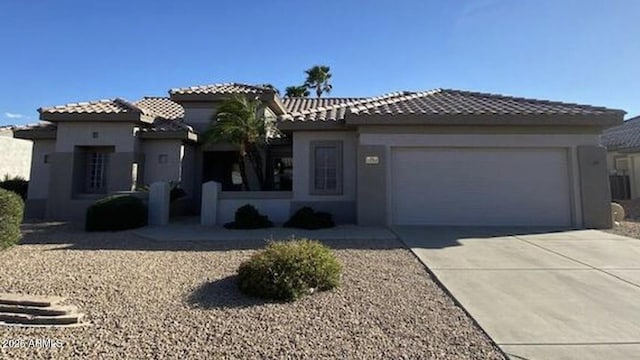 15753 W Kino Dr, Surprise, AZ 85374 - view of front of house with an attached garage, concrete driveway, a tile roof, and stucco siding