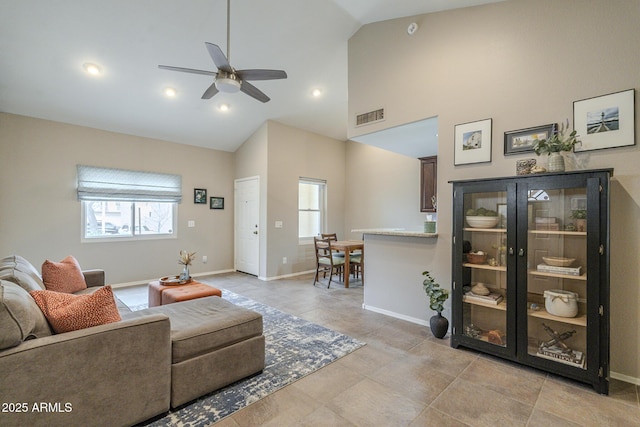 living room featuring ceiling fan, a healthy amount of sunlight, and high vaulted ceiling