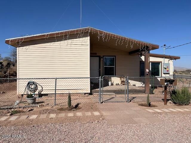 view of property exterior featuring a gate and fence