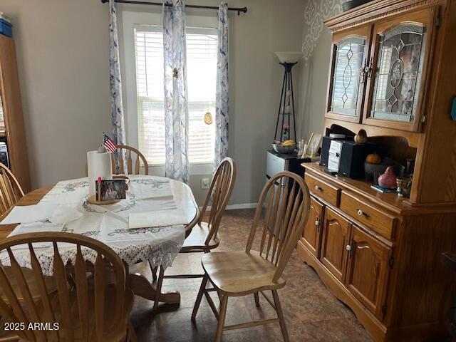 dining space with a wealth of natural light and baseboards