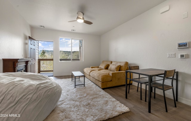 bedroom featuring lofted ceiling, access to exterior, wood-type flooring, and ceiling fan