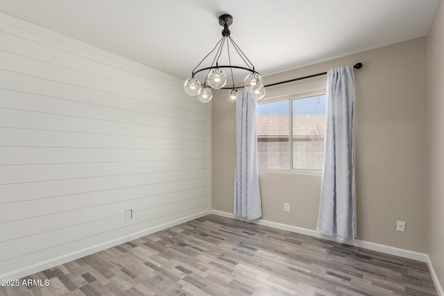 723 N Joshua Tree Ln, Gilbert, AZ 85234 - unfurnished room with a chandelier and wood finished floors