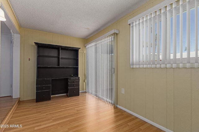 interior space featuring a textured ceiling and wood finished floors