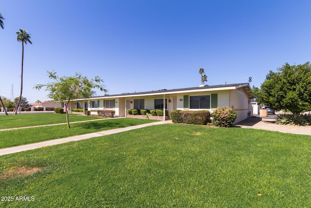 ranch-style home featuring a front yard