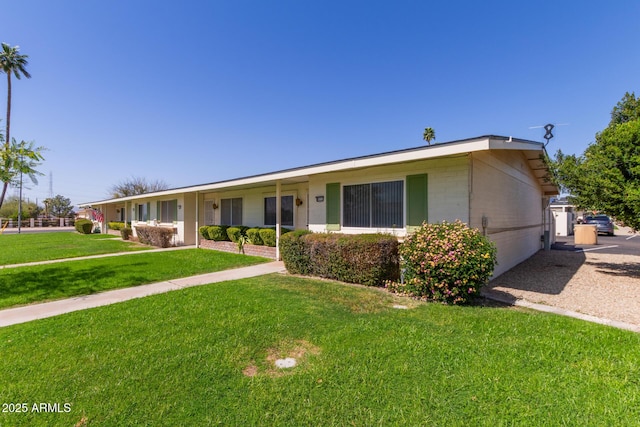 ranch-style home featuring a front yard