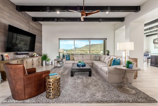 living room with beam ceiling and light wood-type flooring