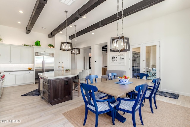 dining room with french doors and beam ceiling