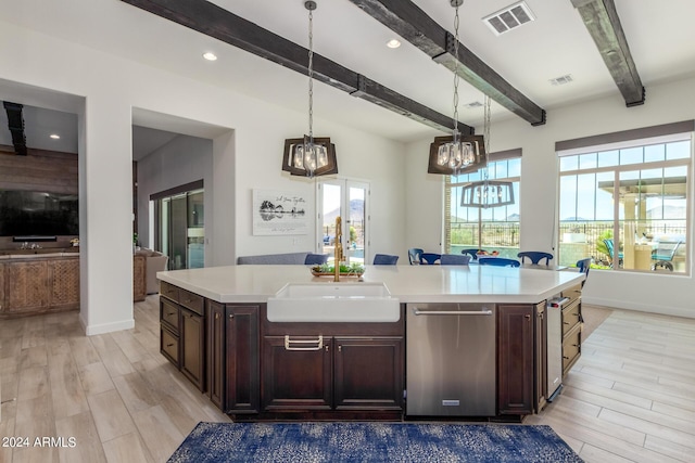 kitchen with pendant lighting, light hardwood / wood-style flooring, sink, beam ceiling, and a kitchen island